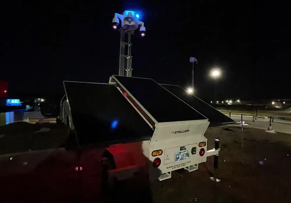 A mobile surveillance trailer with solar security camera panels provides mobile video security and commercial parking lot security at night.