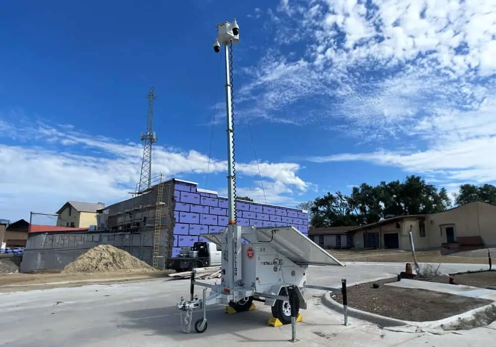 A mobile surveillance trailer with solar security cameras at a construction site for parking lot security and commercial video monitoring.