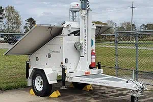 Mobile surveillance trailer with solar security camera for commercial parking lot security.