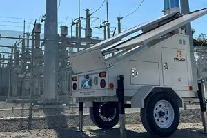 A mobile surveillance trailer with solar security camera monitors a substation, showcasing mobile video security and commercial security systems.