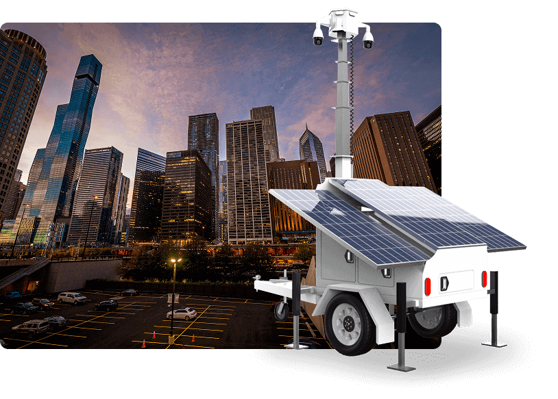 Mobile surveillance trailer with solar security cameras for parking lot and commercial security at dusk.